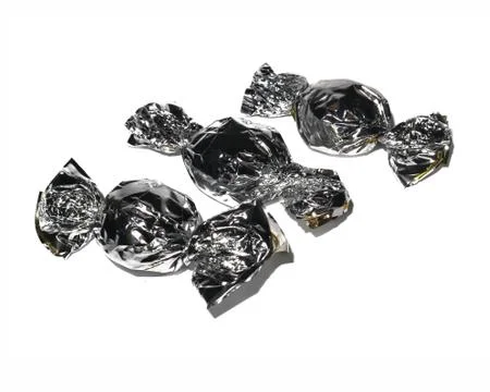Candy wrapper foil on white background isolate. Stock Photos
