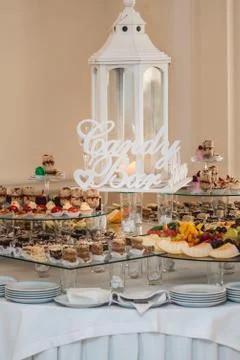 Candybar in a restaurant. Decorated white table fool of sweet pastry Stock Photos