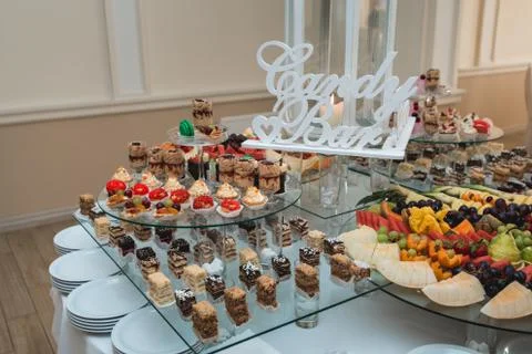 Candybar in a restaurant. Decorated white table fool of sweet pastry Stock Photos