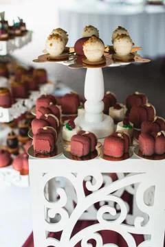 Candybar in a restaurant. Decorated white table fool of sweet pastry Stock Photos