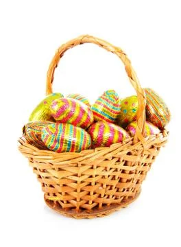 Cane basket with colorful easter eggs Foto stock