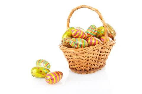 Cane basket with colorful easter eggs Stock Photos