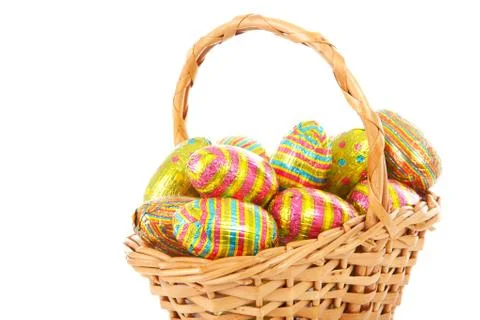Cane basket with colorful easter eggs Stock Photos
