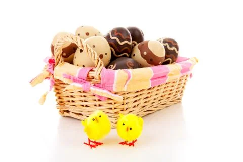 Cane basket with easter eggs Stock Photos