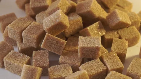 Cane lump sugar. rotating brown sugar cubes. Demerara golden brown sugar 011 Stock Footage 154175666
