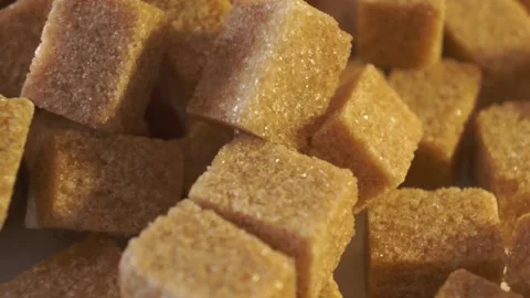 Cane lump sugar. rotating brown sugar cubes. Demerara golden brown sugar 014 Stock Footage 154175689