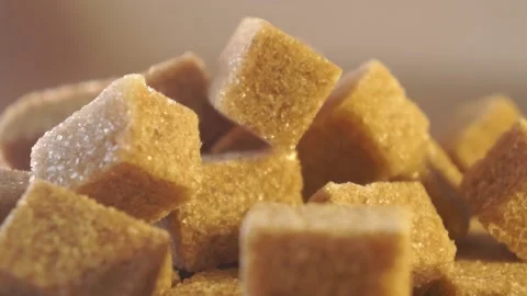 Cane lump sugar. rotating brown sugar cubes. Demerara golden brown sugar 013 Stock Footage 154175694