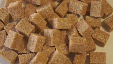 Cane lump sugar. rotating brown sugar cubes. Demerara golden brown sugar 016 Stock Footage 154176102