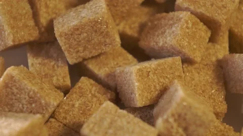 Cane lump sugar. rotating brown sugar cubes. Demerara golden brown sugar 017 Stock Footage 154176136
