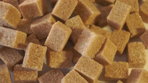 Cane lump sugar. rotating brown sugar cubes. Demerara golden brown sugar 015 Stock Footage 154176147