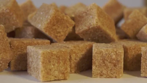 Cane lump sugar. rotating brown sugar cubes. Demerara golden brown sugar 018 Stock Footage 154176314
