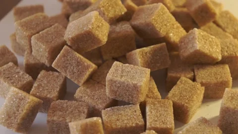 Cane lump sugar. rotating brown sugar cubes. Demerara golden brown sugar  01 Vídeos de archivo 163654927