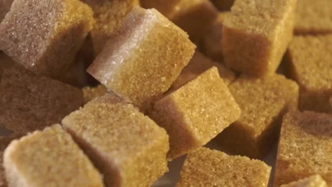 Cane lump sugar. rotating brown sugar cubes. Demerara golden brown sugar  01 Stock Footage 163655233