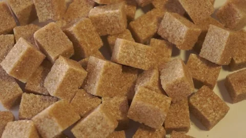 Cane lump sugar. rotating brown sugar cubes. Demerara golden brown sugar  01 Stock Footage 163655504