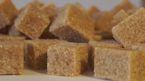 Cane lump sugar. rotating brown sugar cubes. Demerara golden brown sugar  01 Stock Footage 163655718