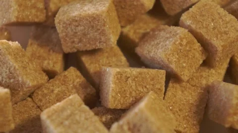 Cane lump sugar. rotating brown sugar cubes. Demerara golden brown sugar  01 Stock Footage 163655735