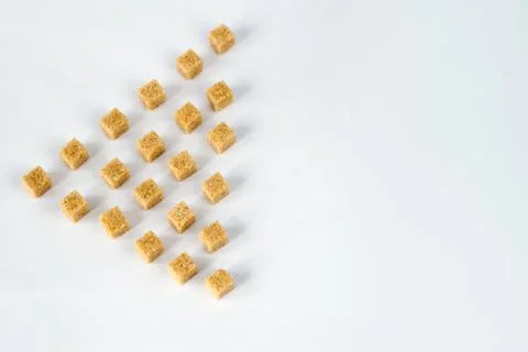 Cane-sugar in cubes isolated on the left, white Stock Photos