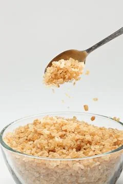 Cane sugar falling from a tea-spoon Stock Photos