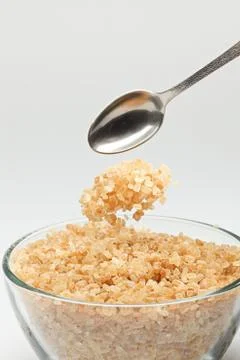 Cane sugar falling from a tea-spoon Stock Photos