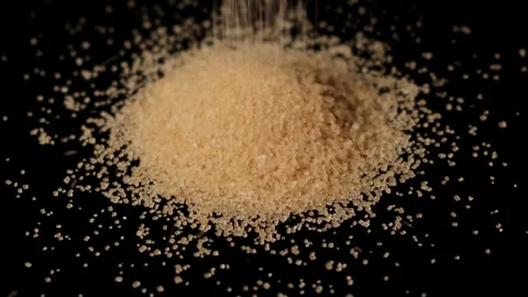 Cane sugar poured on a table on a black background. Stock Footage 295225258