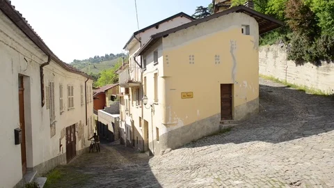 Canelli, guy with a Bicycle passing by a round house Stock Footage 79594542