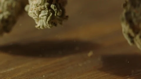 Cannabis buds bouncing wood table 스톡 동영상 94346710