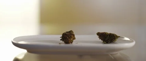 Cannabis buds falling on a plate, slow motion, CBD, THC footage, close up Stock Footage 119990667