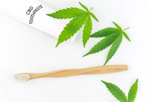 Cannabis CBD toothpaste with Cannabis leafs and wooden toothbrush Stock Photos