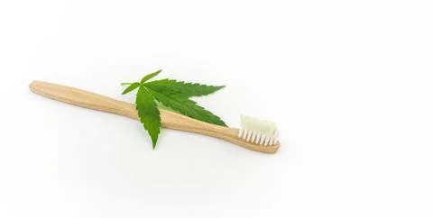 Cannabis CBD toothpaste with Cannabis leafs and wooden toothbrush Stock Photos