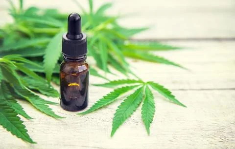 Cannabis extract in a small bottle. Selective focus. Stock Photos