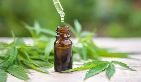 Cannabis extract in a small bottle. Selective focus. Stock Photos