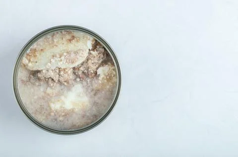 Canned beef. Open tin on white background Stock Photos