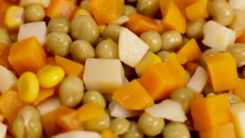 Canned boiled vegetables - peas, corn, carrots rotate, close-up Stock Footage 230180764