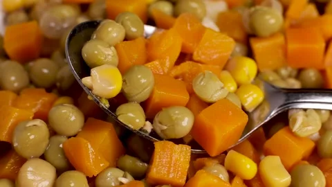 Canned boiled vegetables - peas, corn, carrots rotate, close-up Stock Footage 230180823