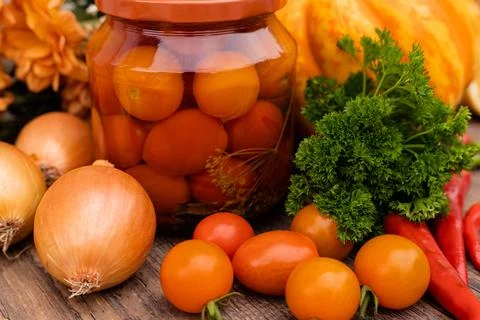 Canned cherry tomatoes. Vegetables for preservation on the table in the kitchen Stock Photos