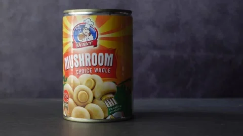 Canned mushrooms in a container on table Stock Footage 188879131