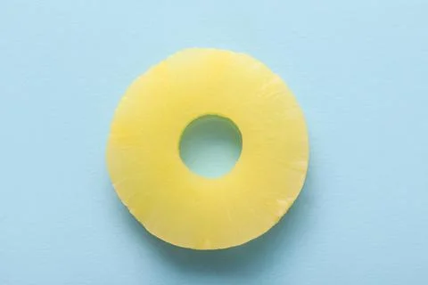 Canned pineapple ring on blue background Stock Photos