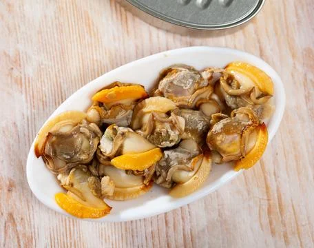 Canned shellfish on plate Stock Photos