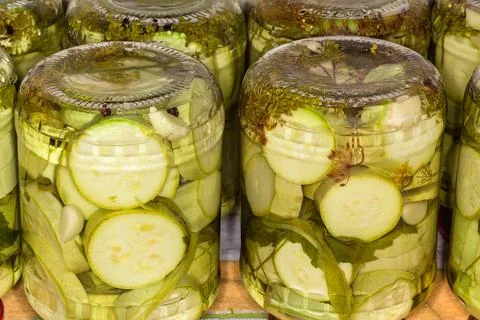 Canned vegetable marrow in upside-down glass jars close-up Stock Photos