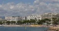 Cannes City Skyline with People Sunbathing and Swimming Beach of French Riviera 4k or 4k+ Resolution