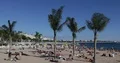 Cannes Skyline with People Sunbathing and Swimming on Beach of French Riviera 4k or 4k+ Resolution