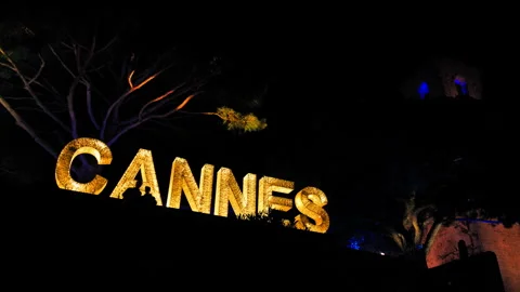Cannes text on top of a mountain lit up at night in Cannes, a sign of the city. Stock Footage 247218388