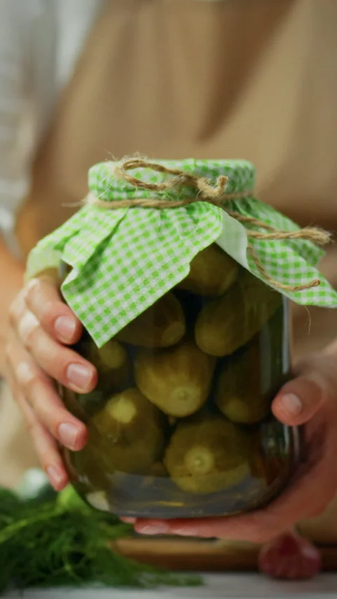 Canning cucumbers in a private kitchen by a white woman during a home cookin Stock Footage 331536222