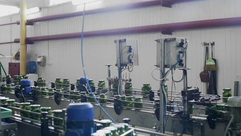Canning plant. Automatic line for processing vegetables. Canned cucumbers. Glass Stock Footage 129264659