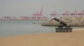 Cannon and cargo cranes on the Sri Lanka beach HD Footage