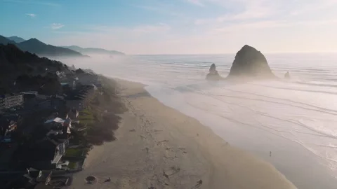 Cannon Beach Drone Footage Featuring Haystack Rock and Coastal Mountains Stock Footage 332084595