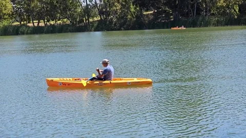 Canoe Boater Taking a Bread Drinking Water Calm Lake Video stock 246873987