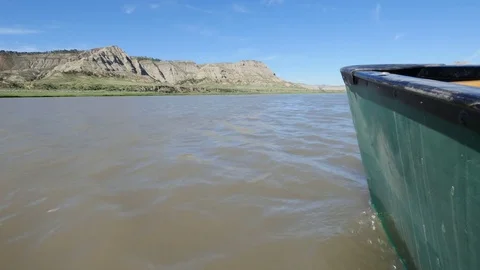 Canoe bow gliding down muddy river Video stock 83690704