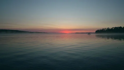 Canoe at dawn on a lake Stock Footage 88296946
