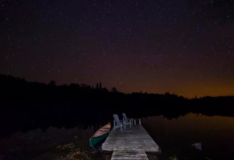 Canoe at dock under a September night sky - Ontario, Canada Stock Photos